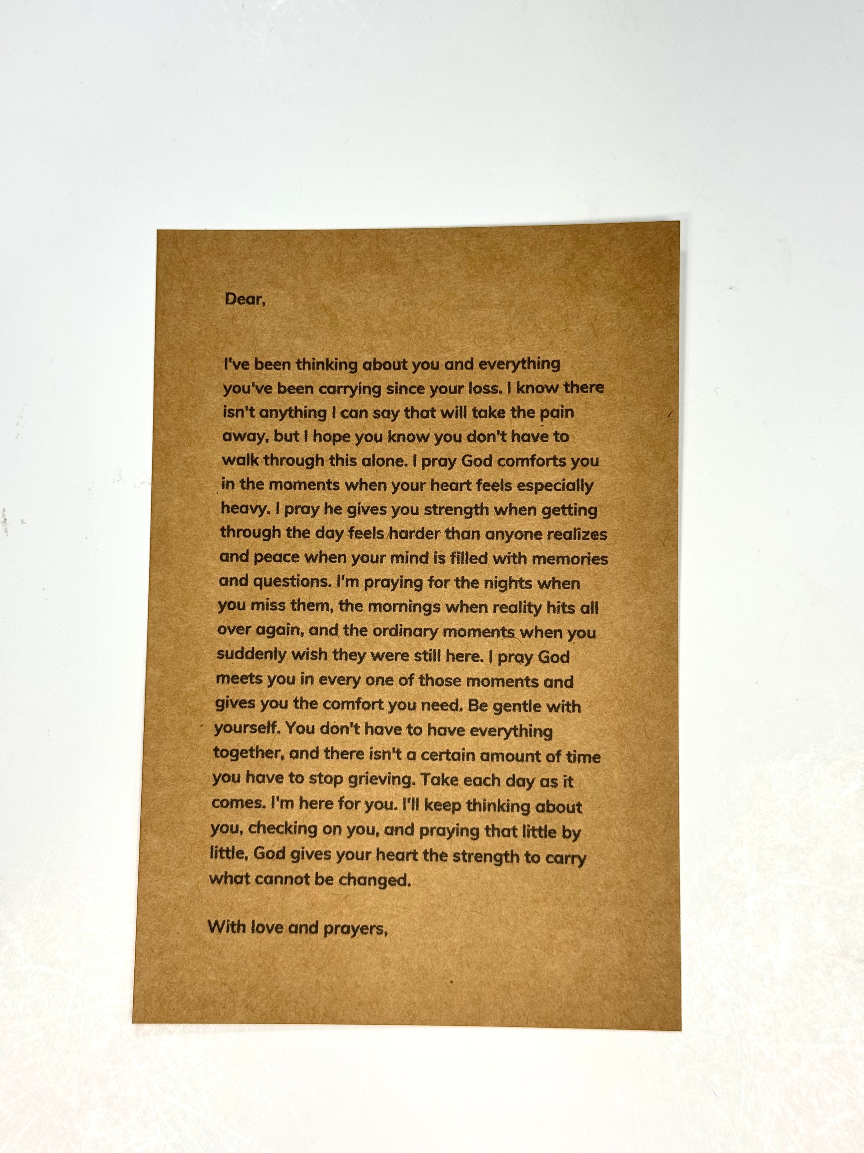 A brown rectangular card with printed sympathy or condolence letter text, photographed against a plain white background.