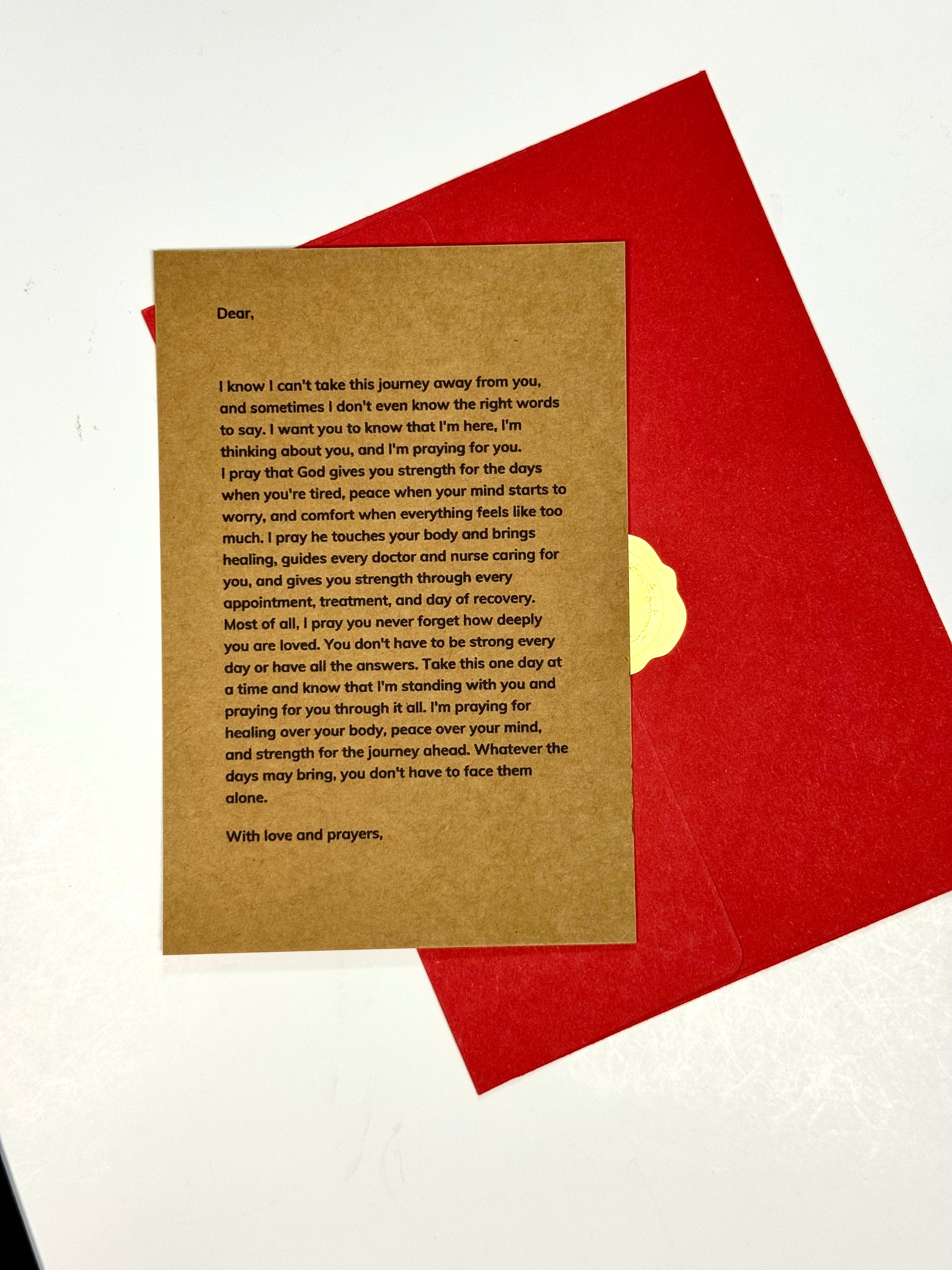 A square kraft paper card with printed condolence text, placed on top of a red envelope or backing sheet against a white background.