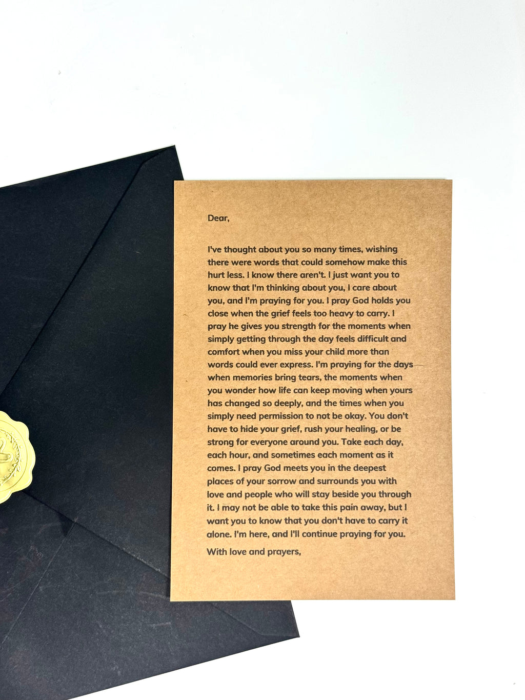 Loss of child condolence letter held in hands with envelope