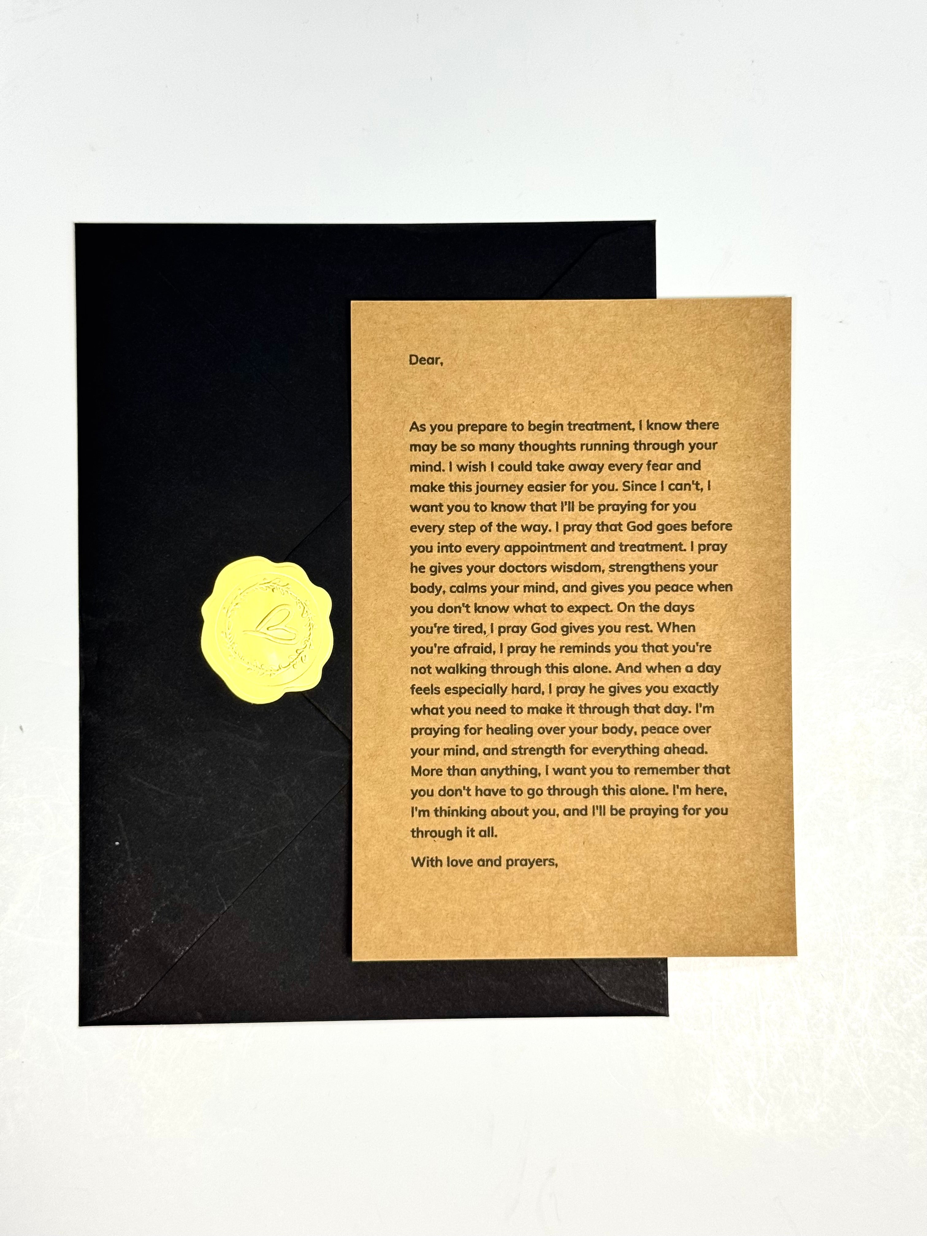 A square printed card or booklet page with a tan parchment-like background and black text, placed over a black textured square on a white studio background.