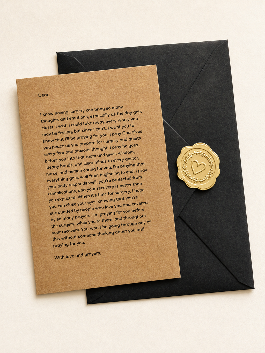 A sympathy card with printed condolence text on a kraft paper background, placed next to a black envelope with a round gold wax seal, on a light beige surface.