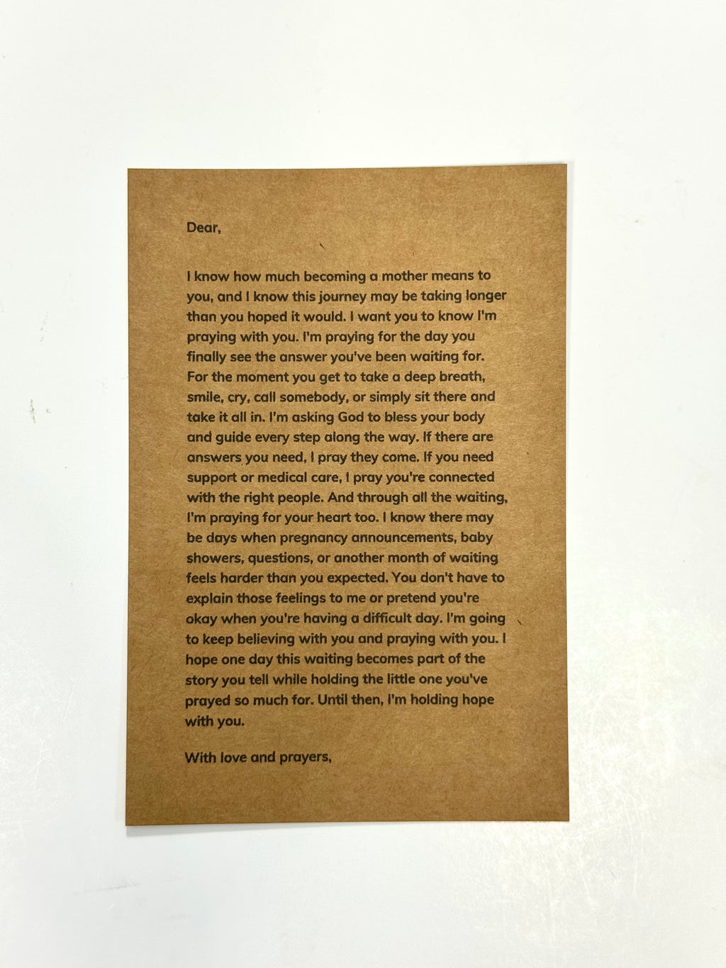 A brown kraft paper card with printed condolence text, photographed against a white background.