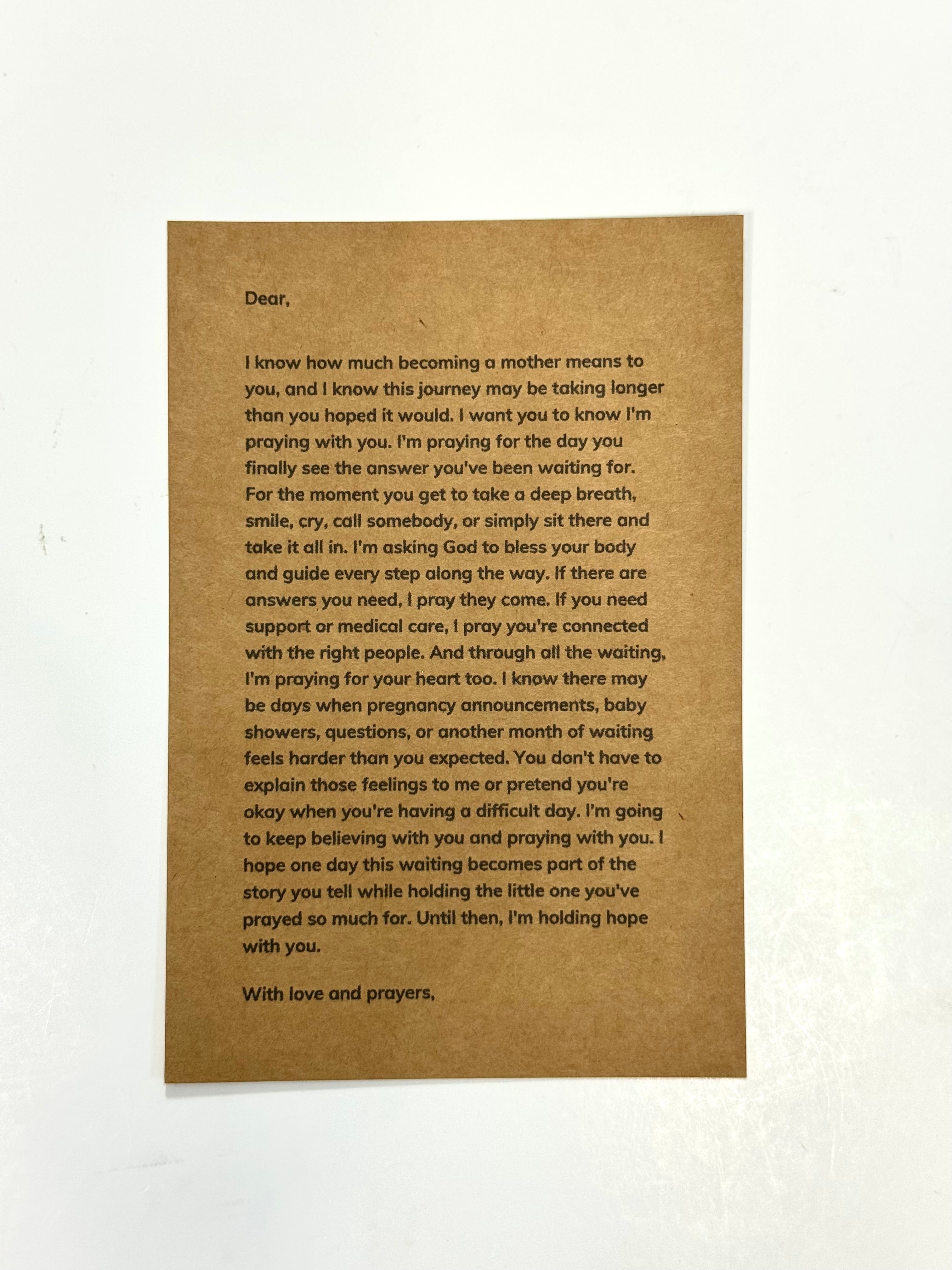 A brown kraft paper card with printed condolence text, photographed against a white background.