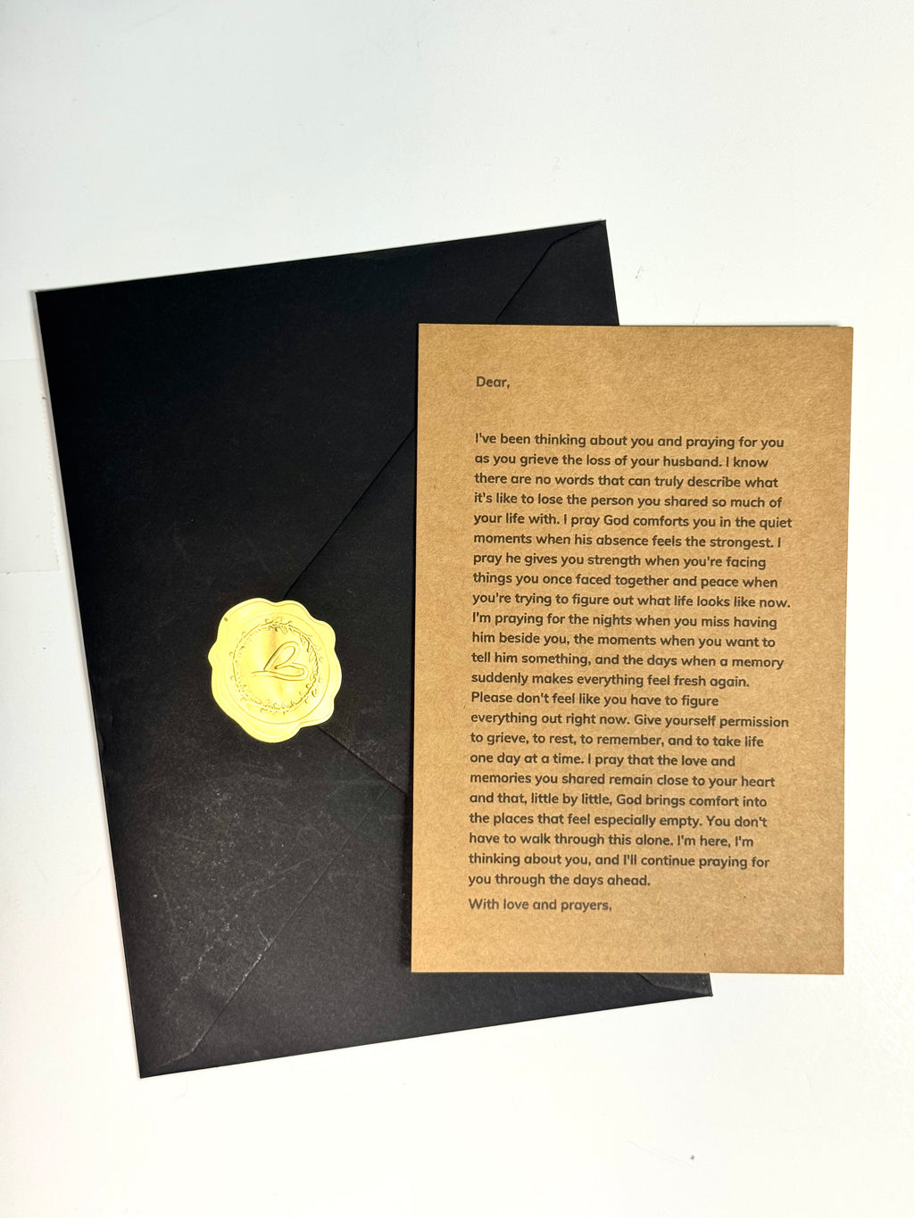 Woman opening loss of husband prayer letter from envelope