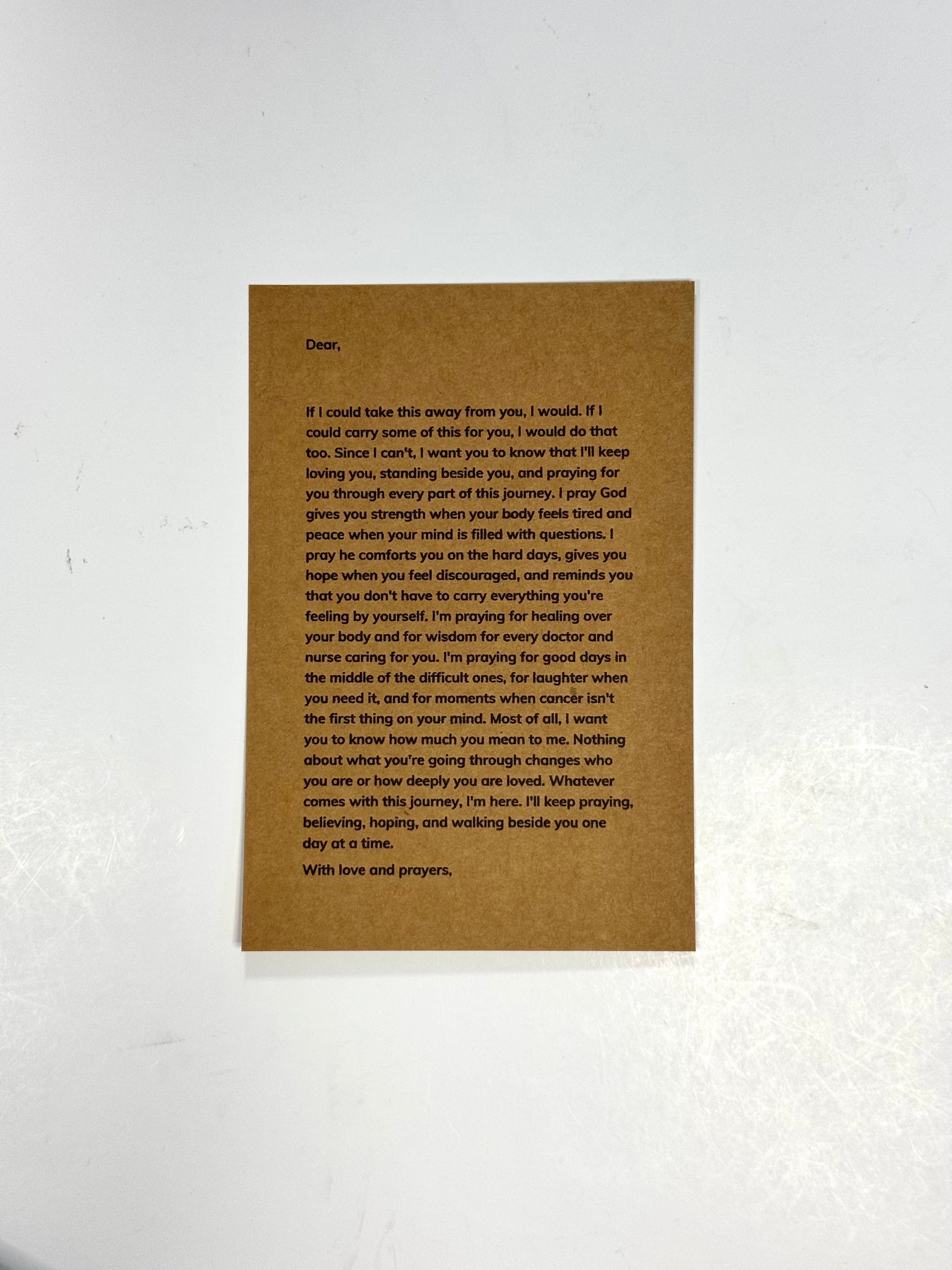 A rectangular brown card with printed black condolence text, photographed against a white textured wall.